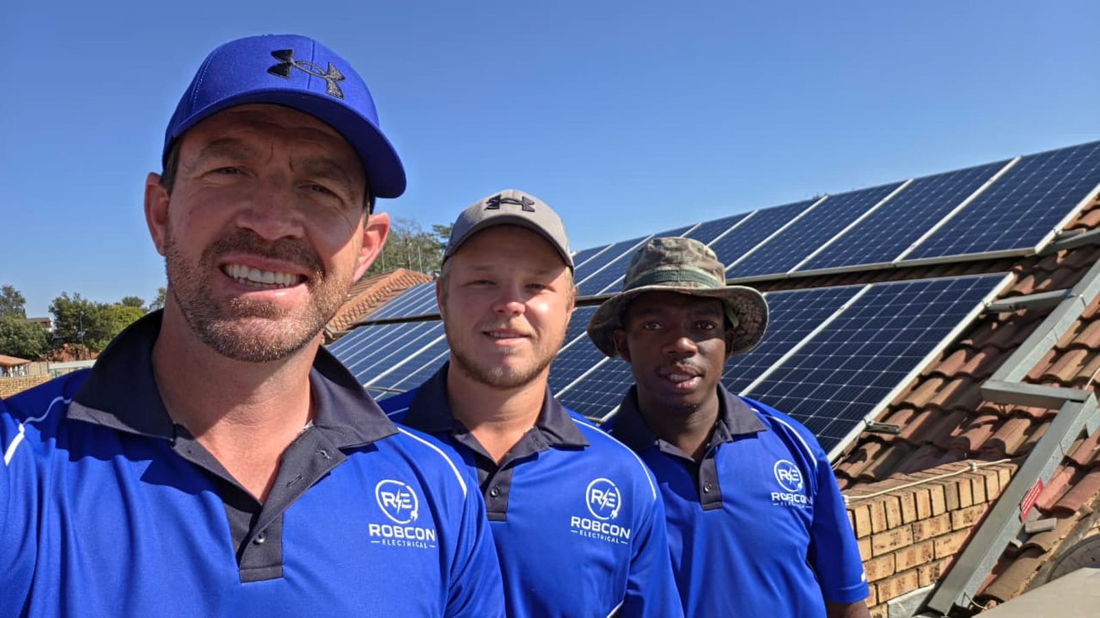 The RobCon Electrical solar cleaning team together on a Pretoria rooftop